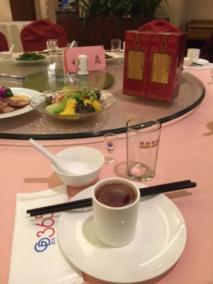 Setting at the table at 365 restaurant, including doll-sized glass for "fire water" .