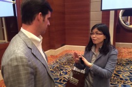 Liang Wang talks to EMBA student Steve Schepman after the panel discussion. 