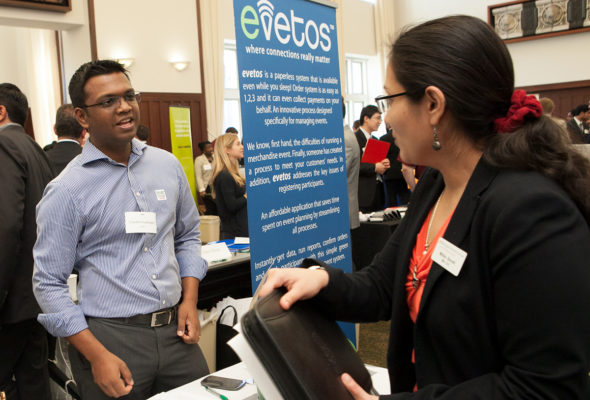 A student meets with a representative from evetos at the 2013 Meet the Firms event. 