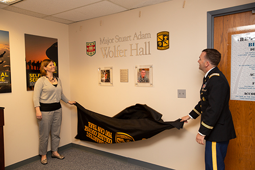 Lee Wolfer of Eagle, Idaho, the widow of Stuart Adam Wolfer, and ROTC Lt. Col. James Craig, unveil a memorial during the Stuart Wolfer Memorial Event at the North Campus of Washington University on April 18, 2018. Photo by Jerry Naunheim Jr.
