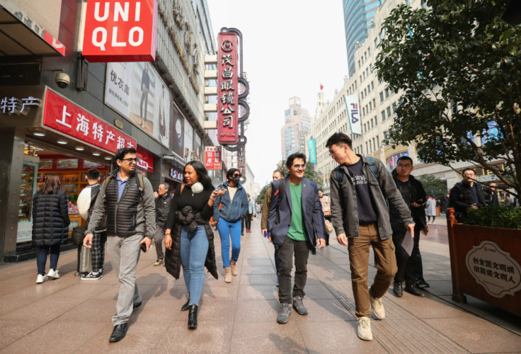 Students in the global operations course in Shanghai over spring break 2019 evaluating fashion retailers on Nanjing Road.