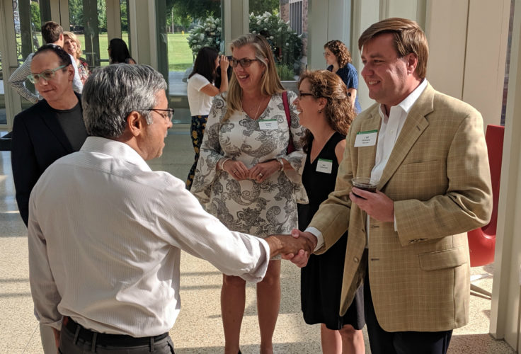At a farewell reception in his honor, Cliff Holekamp greets Mahendra Gupta, the former Olin dean who hired him as the first full-time entrepreneurship professor for the business school.