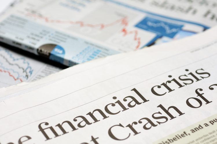 Newspapers with portion of "financial crisis" headline.