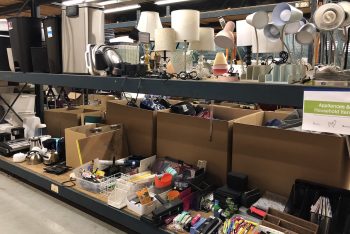 An assortment of lamps and appliances for sale.