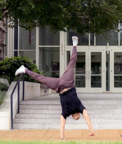 Aaron Samuels does a cartwheel on campus.