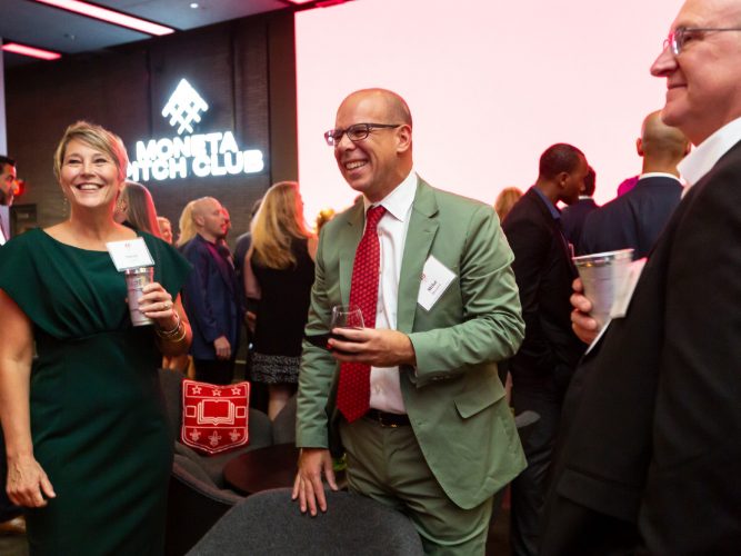 WashU Olin Dean Mike Mazzeo celebrates with guests at the EMBA 40th anniversary gala at St. Louis SC CITYPARK.