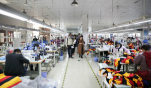 Students in Fuqiang Zhang's global operations course tour the Mudoo Fashion garment factory outside of Shanghai. The company was founded by Judy Yu, EMBA '16, in the WashU-Fudan program.